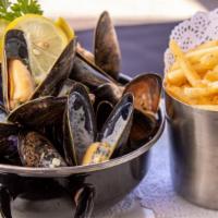 Moules Marinières · Mussels in garlic white wine sauce.