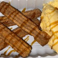 Churros · 4 mini churros filled with cajeta (Mexican caramel) served with vanilla ice cream and carame...
