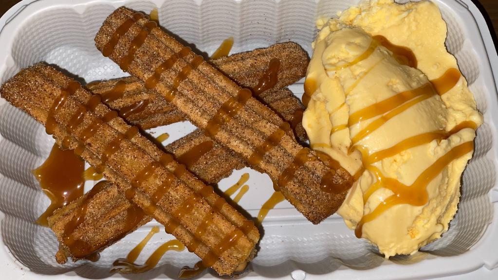 Churros · 4 mini churros filled with cajeta (Mexican caramel) served with vanilla ice cream and caramel drizzle.