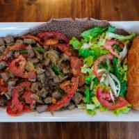 Beef Tibsy · Tender chopped beef sautéed with onion, garlic, jalapeno pepper, organic Eritrean herbal but...