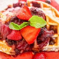 Hot Cheesecake Waffle · Crisp waffle wedges filled with sweet cream cheese, and topped with berry compote.