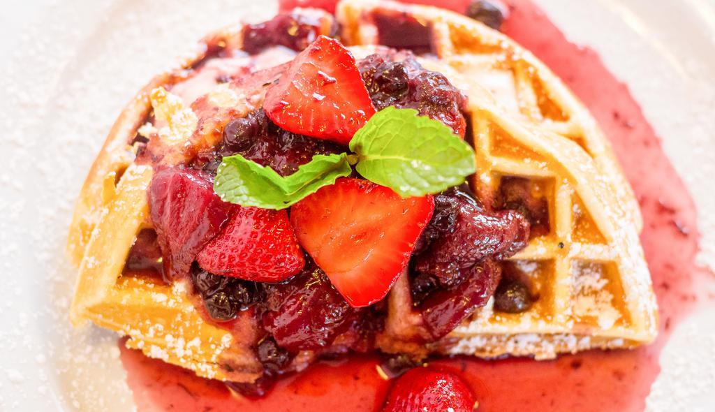 Hot Cheesecake Waffle · Crisp waffle wedges filled with sweet cream cheese, and topped with berry compote.