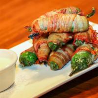 House Made Bacon Wrapped Jalapenos · Cream cheese and spinach stuffed jalapenos, wrapped in bacon and deep fried to perfection. S...