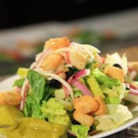 Traditional House Salad · Romaine lettuce, garbanzo beans, olives, salami, red onions, mozzarella cheese, and pepperon...