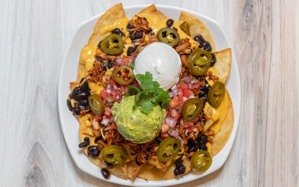 Nacho Supreme (GF/NF) · Fried corn tortilla chips or french fries, served with cheese sauce, beans, sour cream, pico de gallo, guacamole, jalapenos, and jalapenos.