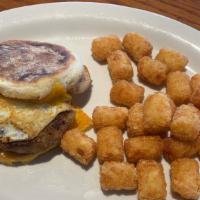 Sausage Breakfast Sandwich · Sausage Breakfast Sandwich with 2 eggs over medium topped with cheddar cheese on english muf...