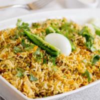 Chicken Biryani · Chicken and saffron rice in biryani herbs served with special house raita and cashew nuts.
