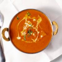 Chicken Tikka Masala-Premium · Composed of grilled chunks of chicken breast meat enveloped in a buttery, creamy sauce.