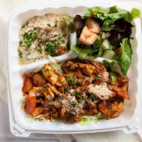 Shawarma Plate · Thinly cut, marinated slices of meat served with broiled fresh tomatoes, hummus dip, fresh c...