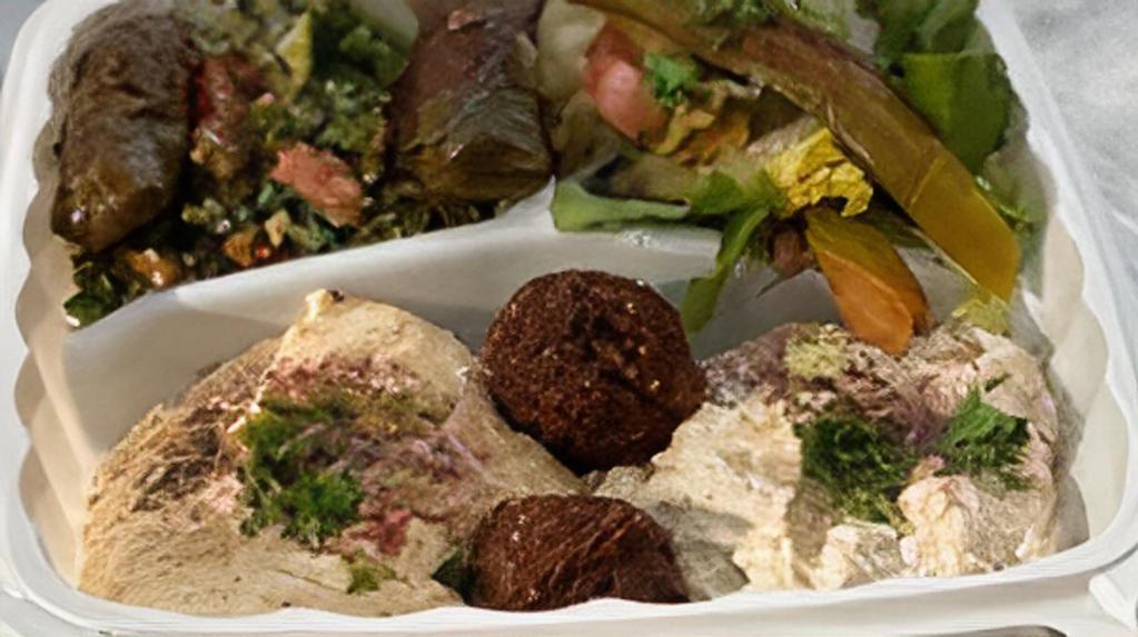 Combo Plate · Vegetarian. Hummus, falafels, tabouleh, baba ghanoush, salad, dolma, and pita bread.