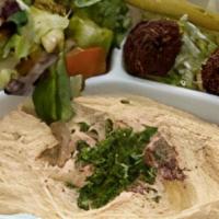 Hummus Plate · Vegetarian. Traditional chickpea dip served with salad, pickles, falafel, and pita bread.