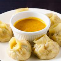Paneer Momos (6 pcs) Steamed · Vegetarian.  Signature Nepali dumplings served with traditional dipping sauce (achar). Momo ...