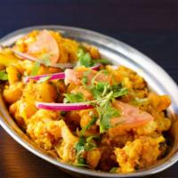 Aloo Gobi · Gluten-Free, Vegan. Roasted potatoes & cauliflower cooked w/ onions, tomatoes, and ginger.