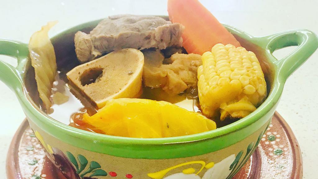 Caldo de Res ( Beef Soup) · Made with a flavorful beef bones and squash, corn, carrots, cabbage and potatoes hand made tortillas .