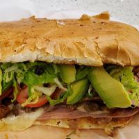 Torta El Tulense · Mexican sandwich bread with pastor, ham ,sausages, mayo, cilantro, lettuce, salsa, tomato, ,...