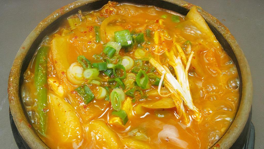 Kimchi Stew · Extra spicy. Served with beef, tofu, glass noodles, onions, and rice cakes. Broth is made with kelp and vegetables.