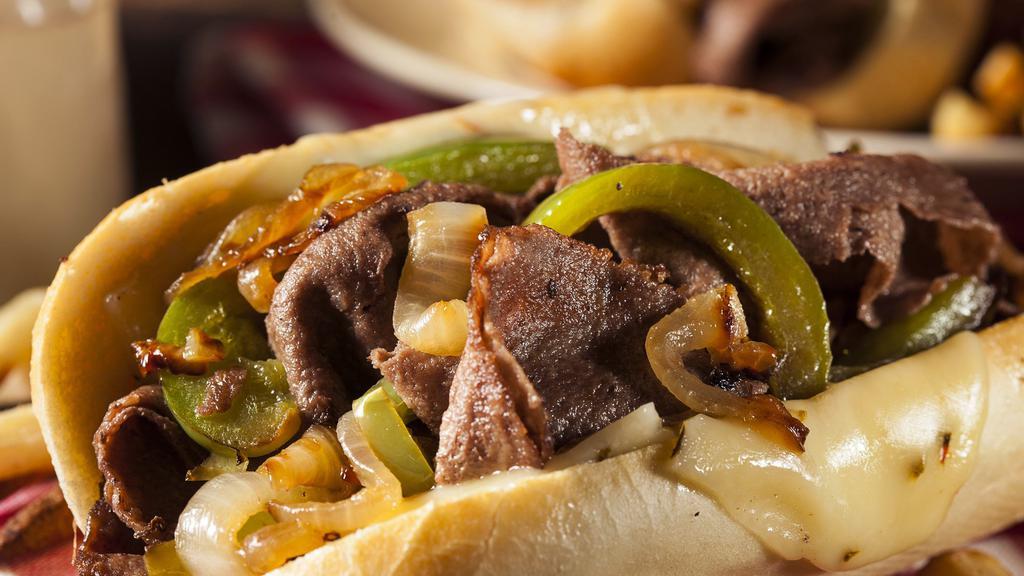 Classic Philly Cheesesteak · Juicy, chopped steak with grilled peppers and onions, melty provolone cheese and mayo on a soft hero roll.