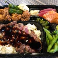 Beef Steak Bento · Sliced beef ribeye with wasabi sauce over rice, fried boneless chicken, sashimi, and edamame...