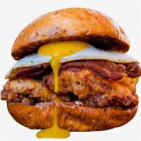 Aussie Fried Chicken Sandwich · Fried chicken served on a toasted bun and topped with bacon, cheddar cheese, mayonnaise, and...