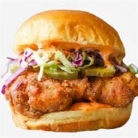 Cheesy Ol' Faithful Fried Chicken Sandwich · Fried chicken served on a toasted bun and topped with coleslaw, cheddar cheese, pickles, and...
