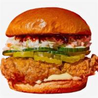 Spicy Korean Fried Chicken Sandwich · Fried chicken served on a toasted bun and topped with coleslaw, pickles, cucumbers, mayonnai...