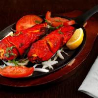 Fish Tandoori · boneless salmon cooked in tandoor (clay oven). marinated with yogurt and special blend of sp...