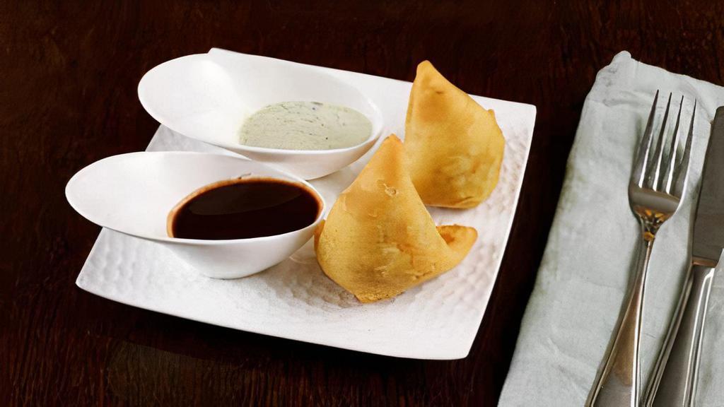 Samosa · 2 pieces per order. A samosa is a fried pastry with a savory filling, such as spiced potatoes, onions, peas.