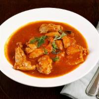 Chicken Curry · Chicken cooked with tomato onion sauce with special blend of spices.