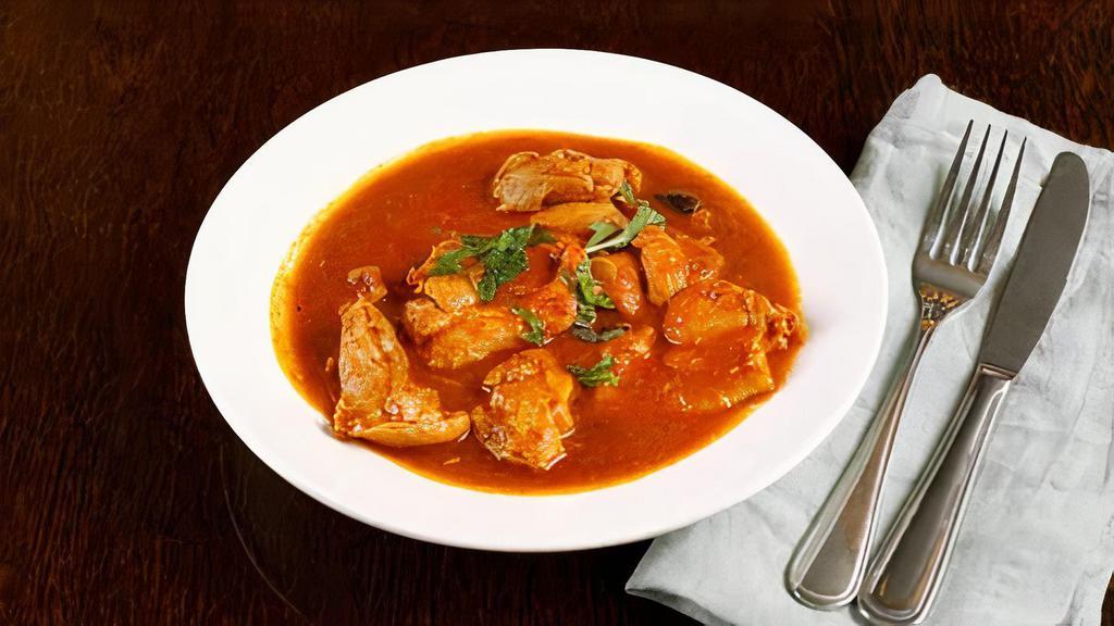 Chicken Curry · Chicken cooked with tomato onion sauce with special blend of spices.
