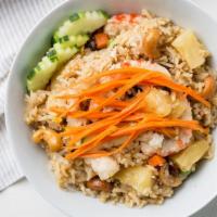 Pineapple Fried Rice · Fried rice with egg, pineapple, veggie shrimp, veggie chicken, cashew nuts, green peas, carr...