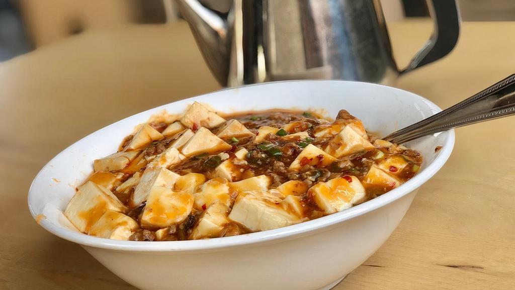 Mapo Tofu / 麻婆豆腐 · Soft tofu set in a light spicy broth, can be made not spicy and vegetarian (if you choose the meatless option).