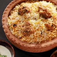 Goat Biryani · Goat blended with aromatic sauce and cooked with aged basmati rice and special spices.