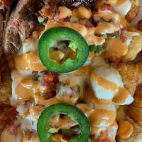 Totchos · Baked tater tots with a three-cheese sauce, homemade pico de gallo, fresh jalapenos, and chi...