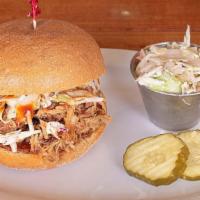 Pulled Pork Sandwich · Seasoned with housemade rub and smoked for hours, our delicious pulled pork is heaped on a f...
