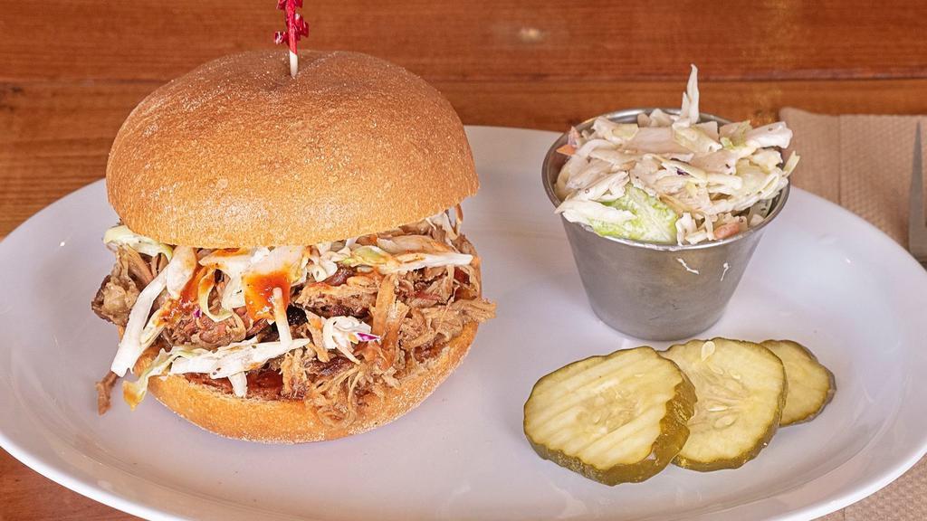 Pulled Pork Sandwich · Seasoned with housemade rub and smoked for hours, our delicious pulled pork is heaped on a fresh roll with coleslaw garnish and Way Station BBQ sauce. Extra coleslaw, pickles and BBQ sauce on the side.