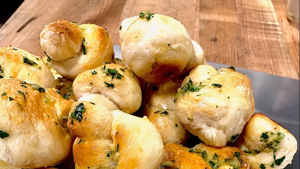 Garlic Knots (6) · Pizza dough tied in a knot, baked and topped with melted butter, garlic and parsley