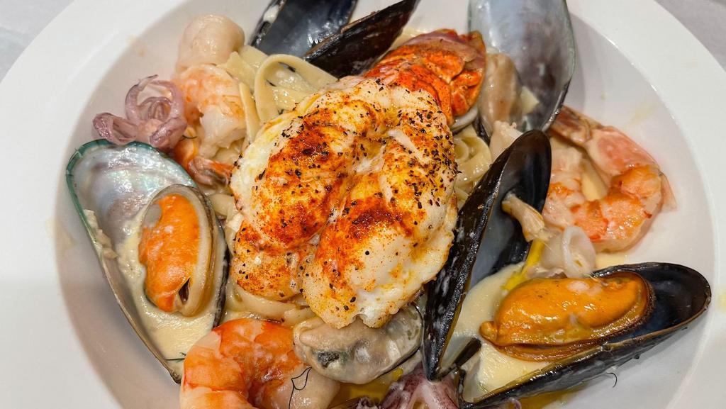 Fettuccine Fruitti Di Mare & Lobster · Fresh Fettuccine Pasta In lobster bisque sauce with mussels, prawns, and calamari. Served alongside a tender and flavorful lobster tail.