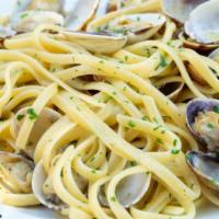 Linguine alle Vongole · Linguine Pasta topped with Fresh chopped garlic, manila clams, Italian parsley served over a...