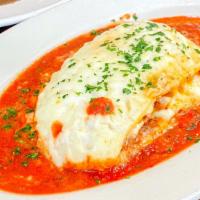 Chicken Lasagna · Made with Chicken, Onions, Basil, Garlic, Tomato Base, Meat Sauce topped with Béchamel Sauce