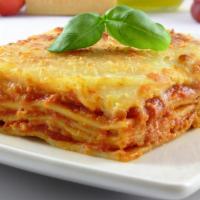 Lasagna Al Forno · Made with Ground Beef, Onions, Basil, Garlic, Tomato Base, Meat Sauce topped with Béchamel S...