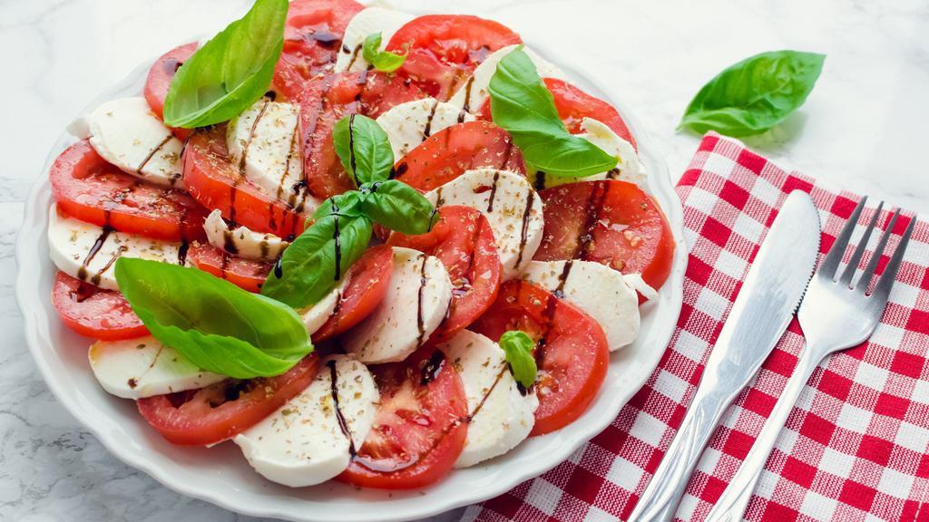 Caprese Salad · Roma Tomatoes, Kalamata Olives, Buffalo Mozzarella, Fresh Basil, Balsamic Vinaigrette, Salt, and Pepper
