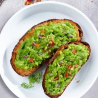 A Toast For Avo · Freshly sliced avocado gently pressed against toast.