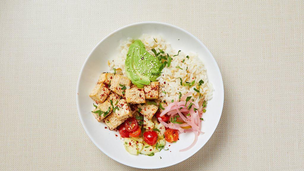 Vegan Tofu Rice Bowl · Gluten-free soy sauce and sesame oil baked tofu, jasmine rice with gluten free orzo, grape tomato, cucumber, parsley, avocado and pickled red onion. Served with hot sauce. Vegan. Gluten-free.