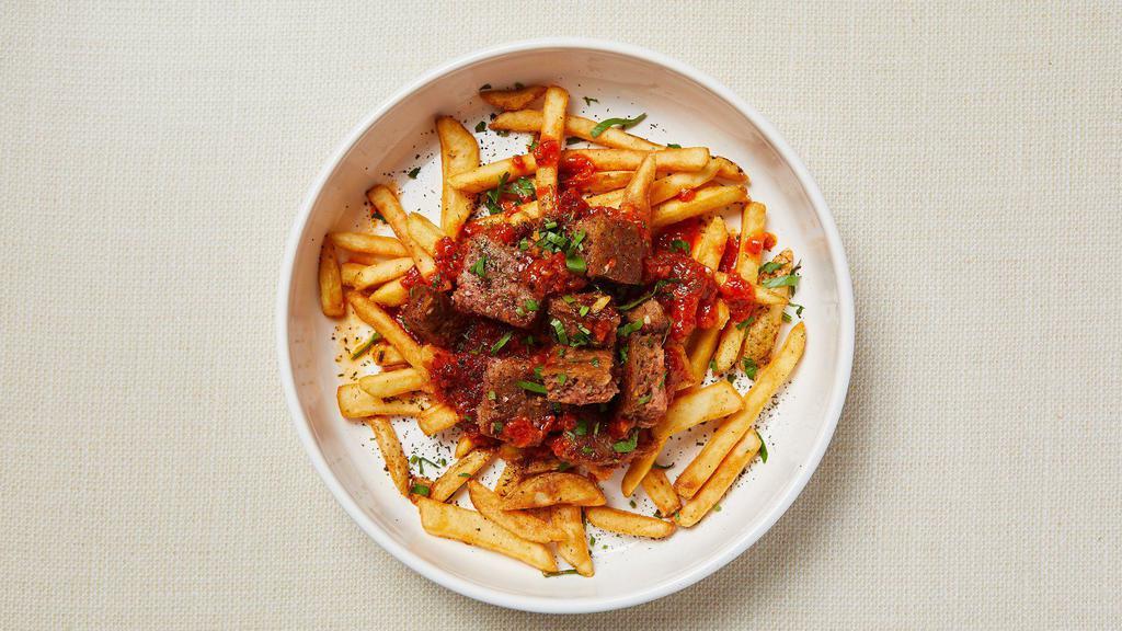 Vegan Beyond Fries Bowl · Beyond (plant-based) meatballs with homemade tomato sauce over a bed of crispy french fries. Vegan. Gluten-free.