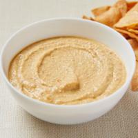 Almond Dip · Homemade almond dip with garlic, lemon and secret spices.  Served with gluten-free corn tort...