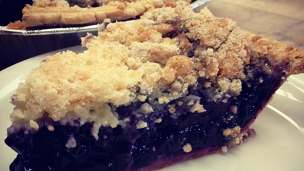Blueberry Crumble Pie · Wild Maine blueberries cohabiting under our butter crumb topping. 6-inch and 9-inch pies.