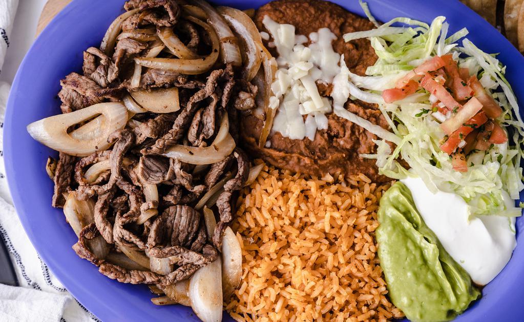 Encebollado · (Beef mixed with Grilled Onions)
Served with:(Rice, Beans, Guacamole, Sour Cream, Cheese, Lettuce, Salsa)
