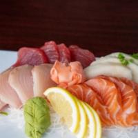 Sashimi Deluxe · Raw. 16 pieces tuna, salmon, hamachi, and escolar, served with a side of white rice.