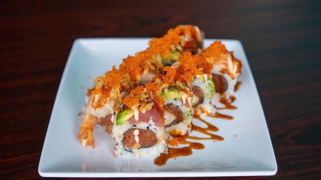 The Roll · Raw. Spicy tuna, shrimp tempura, and cucumber topped with tuna, salmon, hamachi, tempura crunch, tobiko, unagi sauce, and spicy mayo.