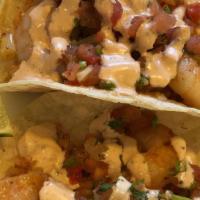 Shrimp Taco · Saute Shrimp with garlic and onions over 2 corn torttilla with rice topped with pico D gallo...